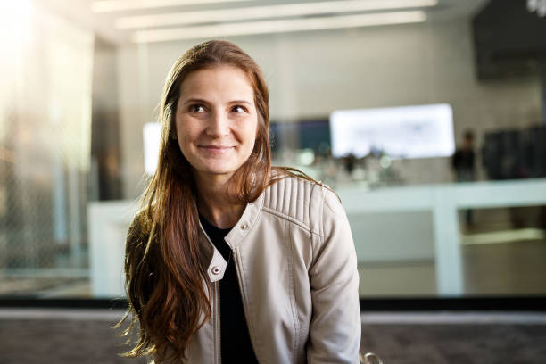 istock Thoughtful woman smiling sitting in the mall 980510044