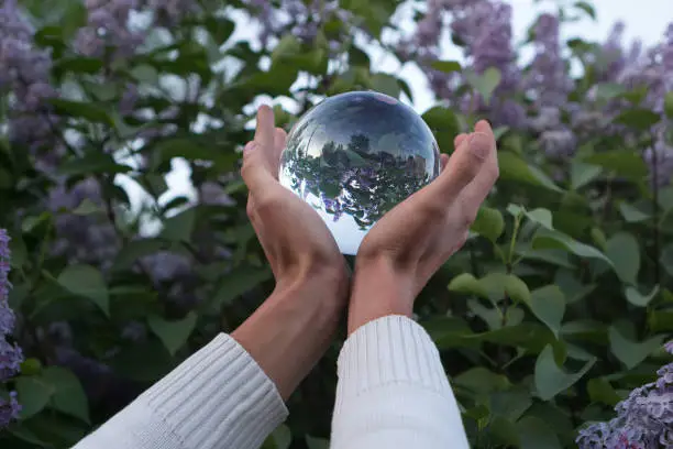 Photo of Contact juggling. Hand and acrylic ball