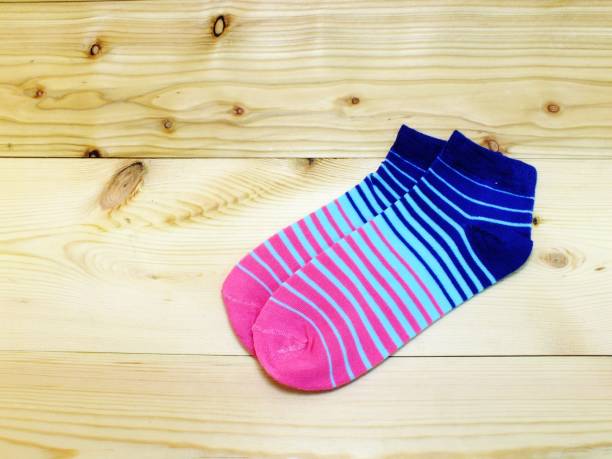 istock blue and pink stripes sock on wooden background 980535236