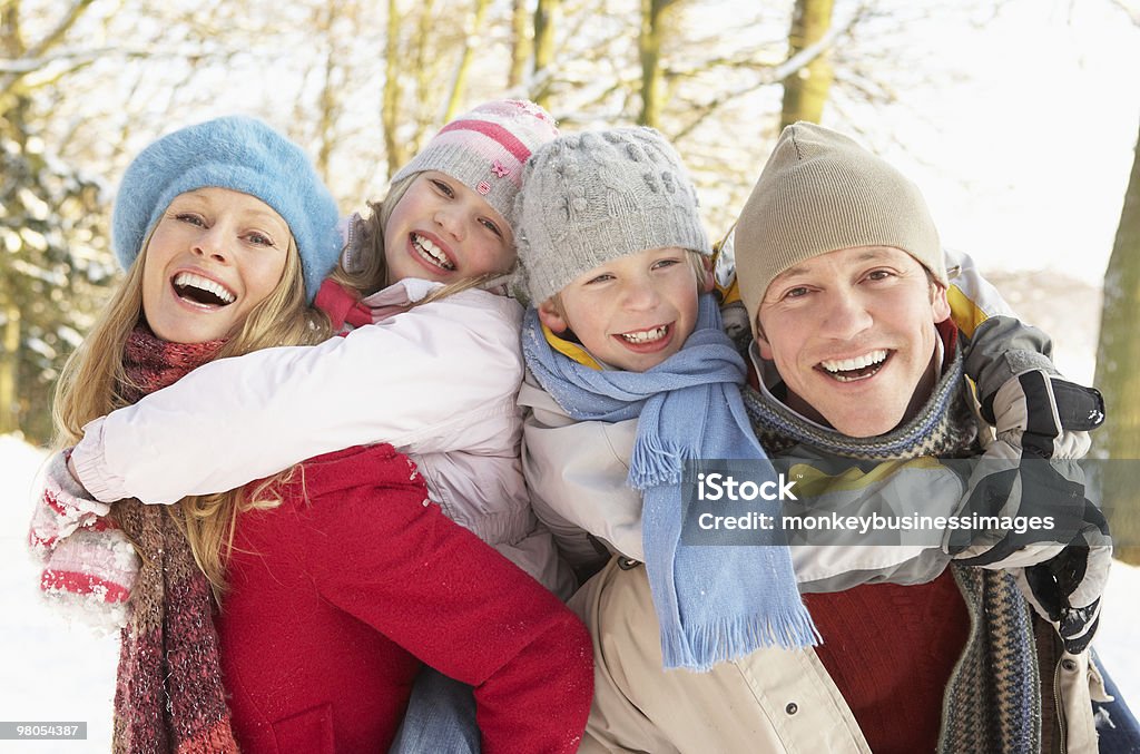 Family Having Fun  in Snowy Woodland Smiling Family Having Fun in Snowy Woodland Family Stock Photo