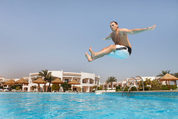 istock Man jumping in swimming pool 98054435