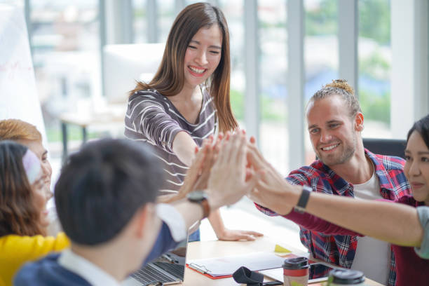 istock High-five for success creative meeting team at modern 980553704