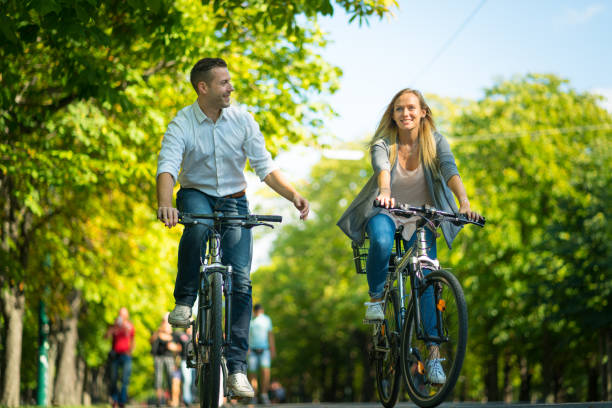 istock happy couple on bikes in park 980592926