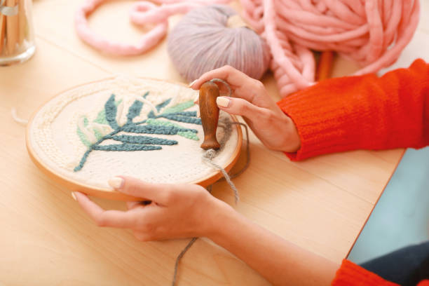 istock Handy needlewoman stitching beautiful ornament 980601734