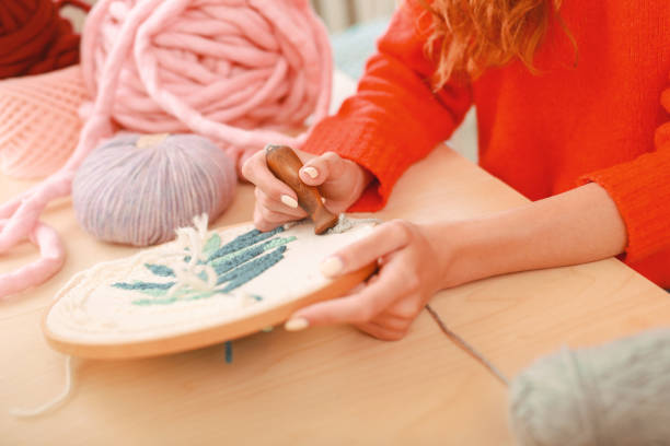 istock Creative woman stitching picture for decorating home 980601770