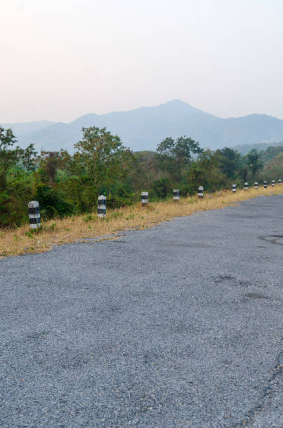 istock roadside pillar in the surface of natural road 980610224