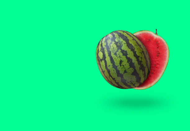 istock Cutted watermelon isolated on green pastel background with a shadow and copy space 980619392