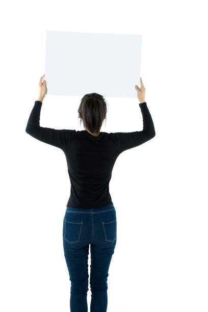 istock Woman holding a blank board on white background 980623656