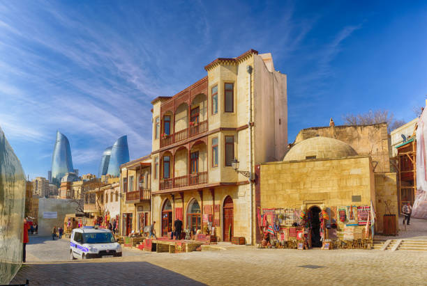traditional street in Baku's old town Baku, Azerbaijan - February 24, 2017: traditional street in Baku's old town with colorful historic buildings with the flame towers skyscrapers in the background baku stock pictures, royalty-free photos & images