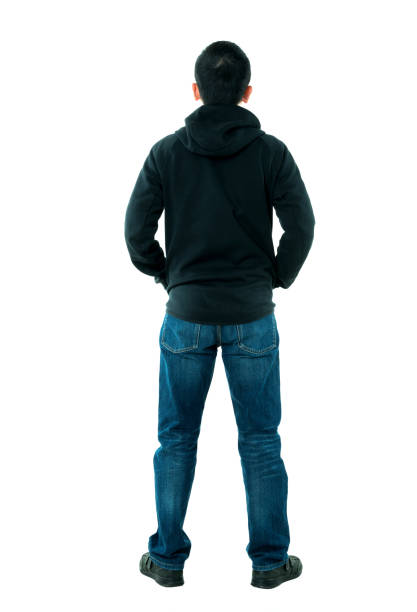 istock Rear view of man standing with hands in pockets 980623924