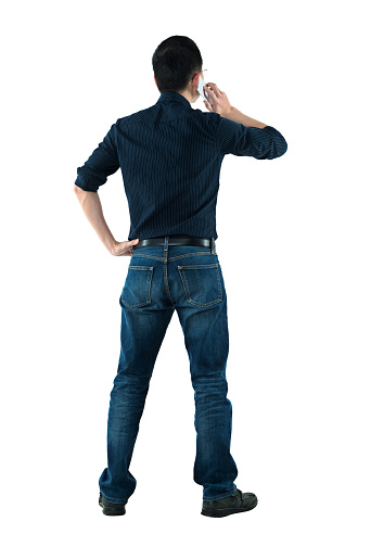 Rear view of businessman talking on mobile phone.