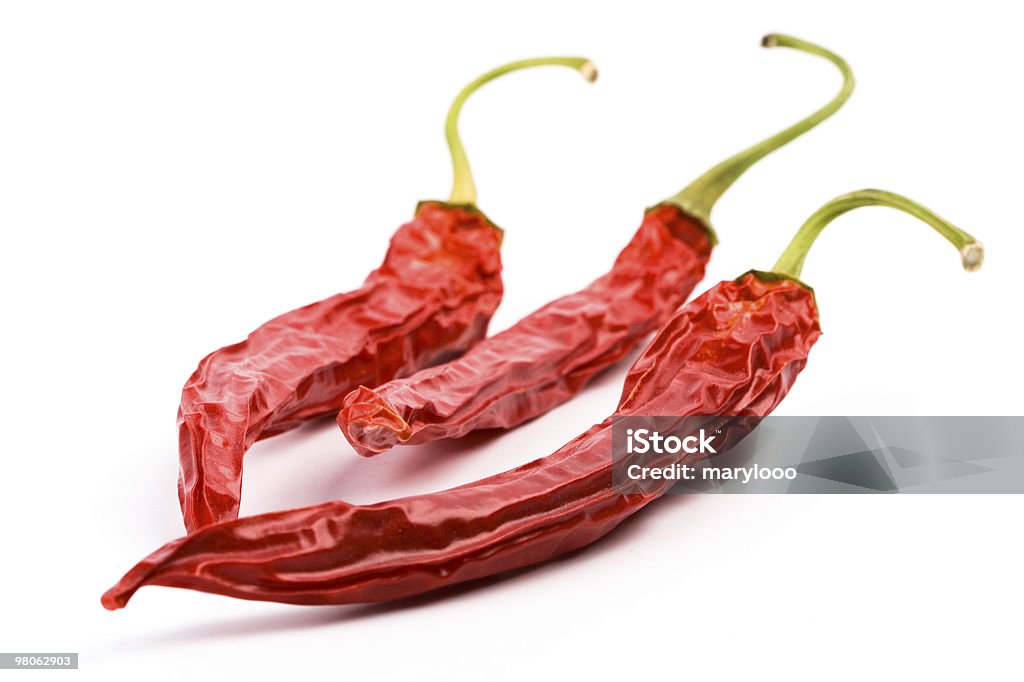 three dry red chili peppers  Bright Stock Photo