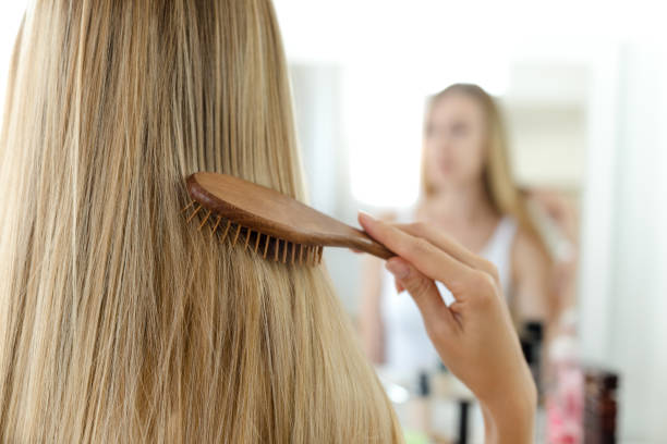 istock Young woman brushing her hair 980633192