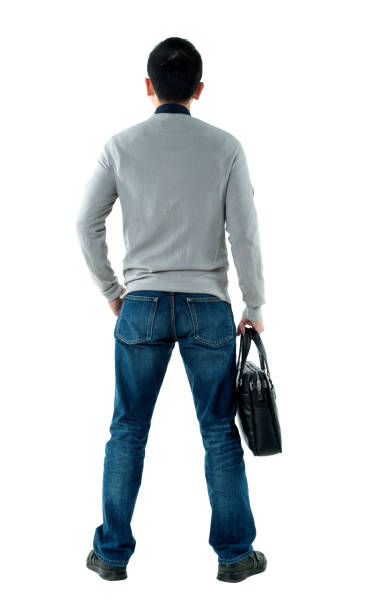 Businessman standing and holding briefcase.