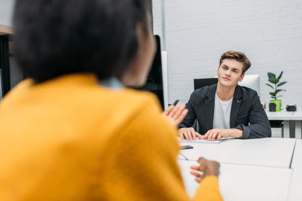 istock business partners talking over worktables at open space office 980642810