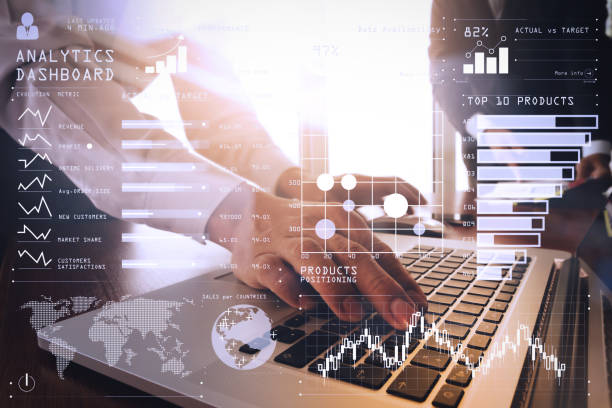 istock business documents on office table with smart phone and blank screen laptop computer and graph business diagram and two colleagues discussing data in the background 980646816