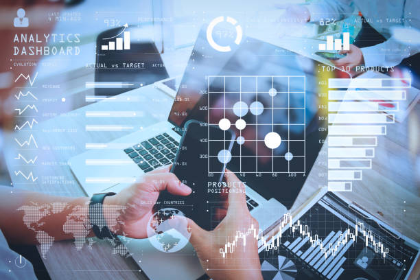 istock business documents on office table with smart phone and laptop computer and graph business with social network diagram and two colleagues discussing data in the background 980647962