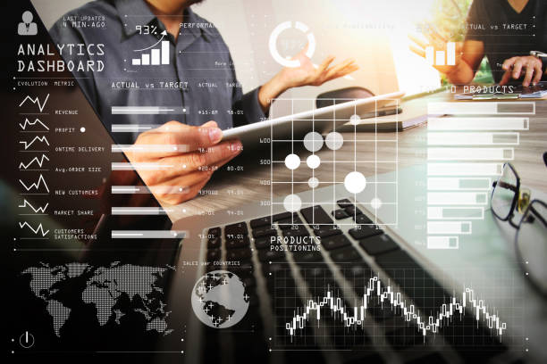 istock business documents on office table with smart phone and laptop computer and graph business with social network diagram and two colleagues discussing data in the background 980650322