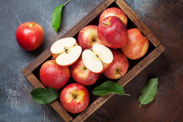 istock Red apples in wooden box 980651098
