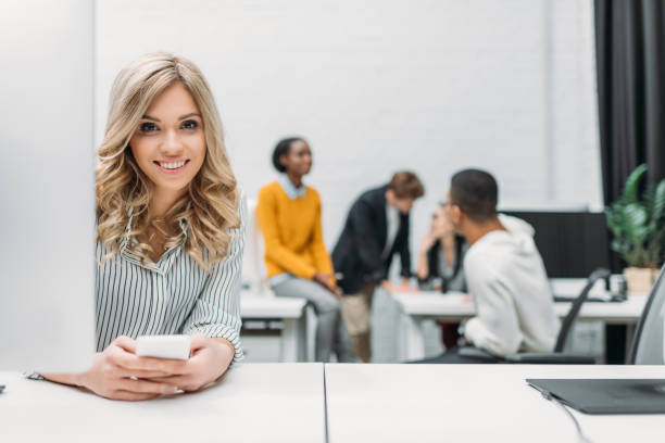 istock young beautiful woman using smartphone at office 980655044