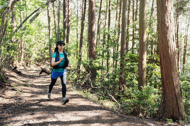 istock Fitness female trail runner running on a mountain path 980655070