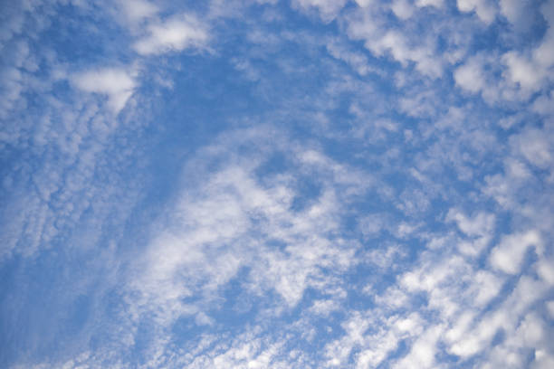istock Blue sky with clouds. Scattered white clouds in the blue sky for text background. 980658678