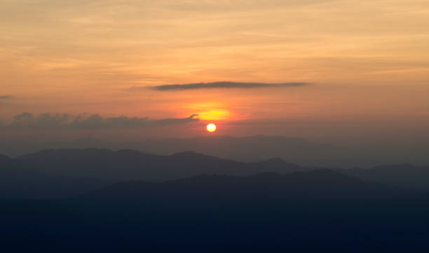 istock Sunset / sunrise with clouds, light rays and other atmospheric effect 980659304