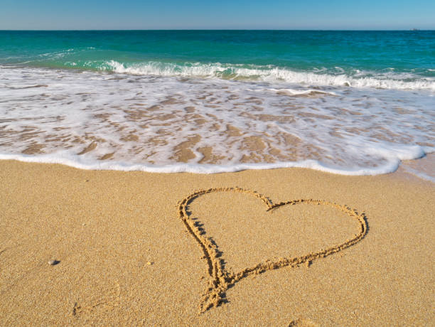 istock Heart on the sand of a beach. 980659358