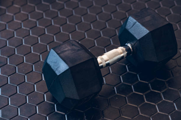istock Black dumbbell on dark hi-tech background 980660072