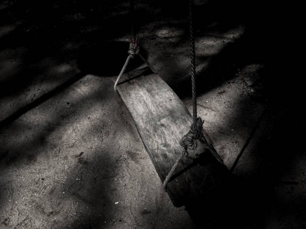 istock Lonely Tree Swing In The Darkness Background 980660646