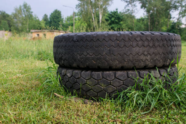 istock Big car tires lie on the grass. 980668558