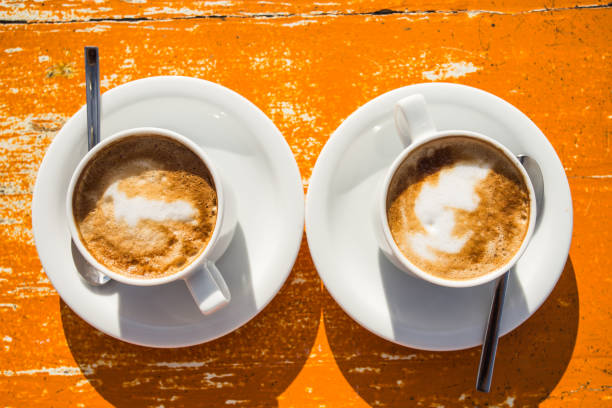 istock Two invigorating cappuccinos on the table await you 980676788