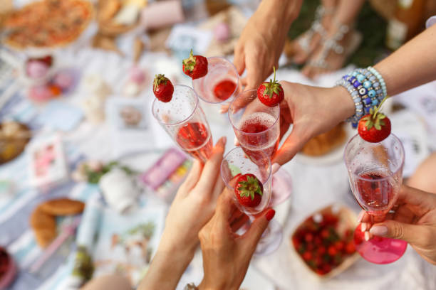 istock Hands with glasses cheers on summer day picnic 980676886