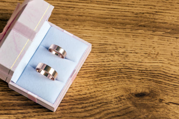 istock Wedding rings in gift box on wooden background. 980677378