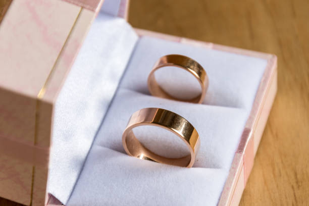 istock Wedding rings in gift box on wooden background. 980677390