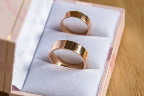 istock Wedding rings in gift box on wooden background. 980677458