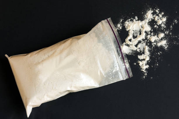 istock Drugs in a plastic bag on black background. 980680152