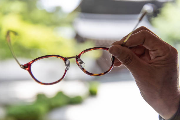 istock Senior man's hand and reading glasses 980680988