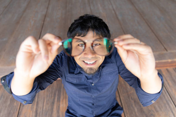 Young man looking through eye glasses