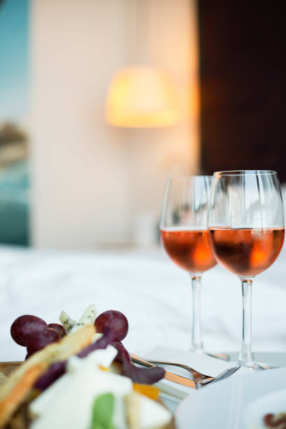 istock Two glass of rose wine and cheese board (selective focus) 980685120