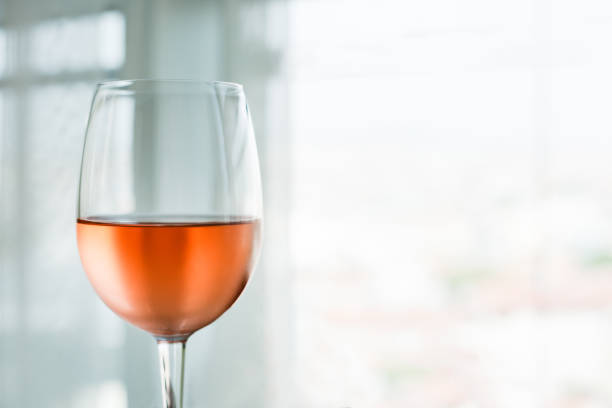 Woman holding glass of rose wine