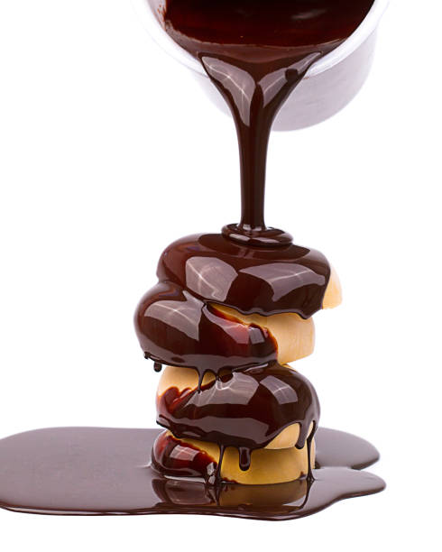 istock Liquid chocolate glazes the cake, and it drips appetizingly and spreads puddle 980694636