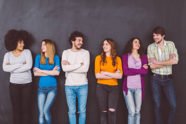 istock Friends with hands crossed standing against blackboard 980697666