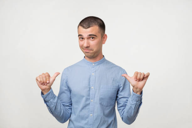 self-satisfied and proud young man looks forward - smug imagens e fotografias de stock