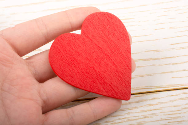 istock Red color heart shaped object in hand 980702632
