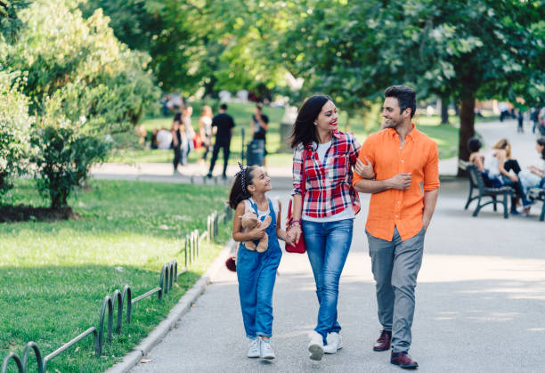 istock Young family walking in the park 980705978