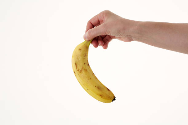 istock Hand holding a banana 980707012