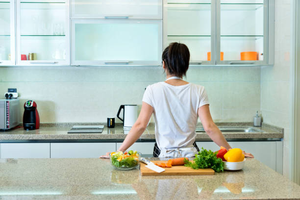 istock Woman preparing to make vegetable salads 980721110