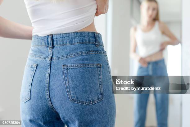 Woman Checking Her Body Stock Photo - Download Image Now - Women, Anorexia Nervosa, Jeans