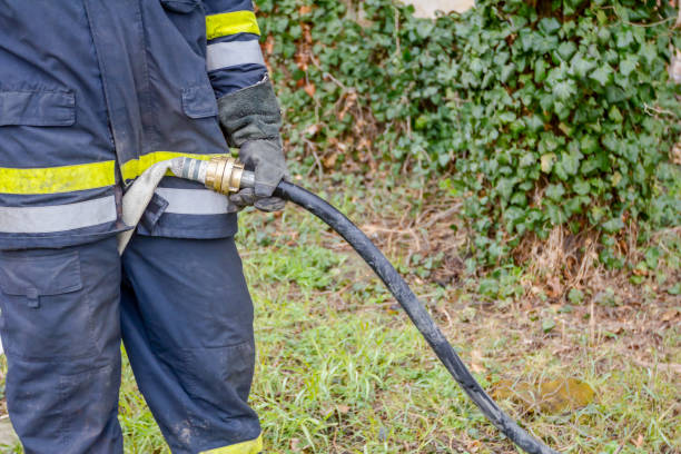 istock Fireman is helping colleague to attach nozzle to the hose 980748860